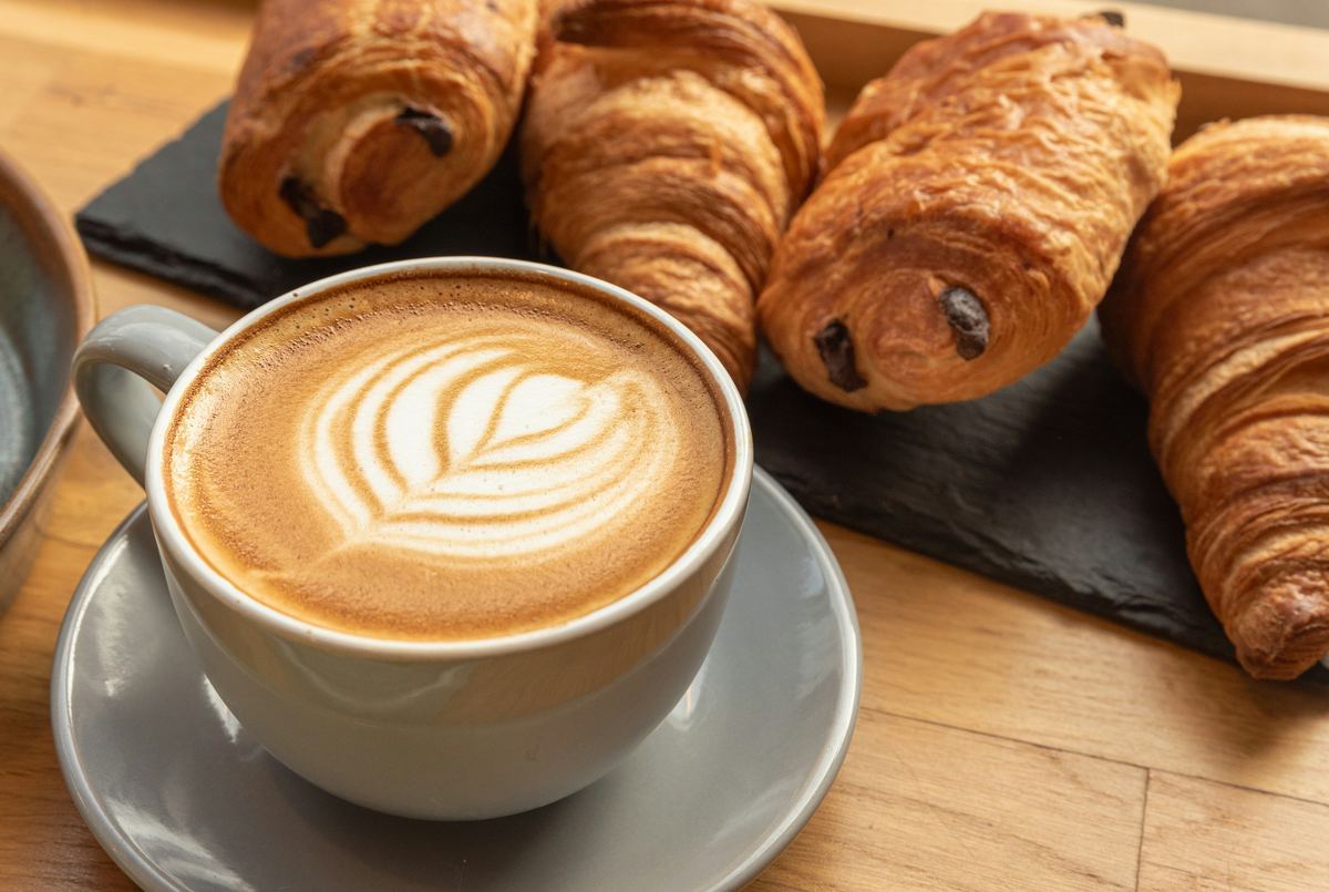 Croissants en chocoladebroodjes naast een kop koffie